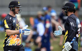 Wellington Firebirds Tom Blundell and Michael Pollard celebrate their 100 partnership