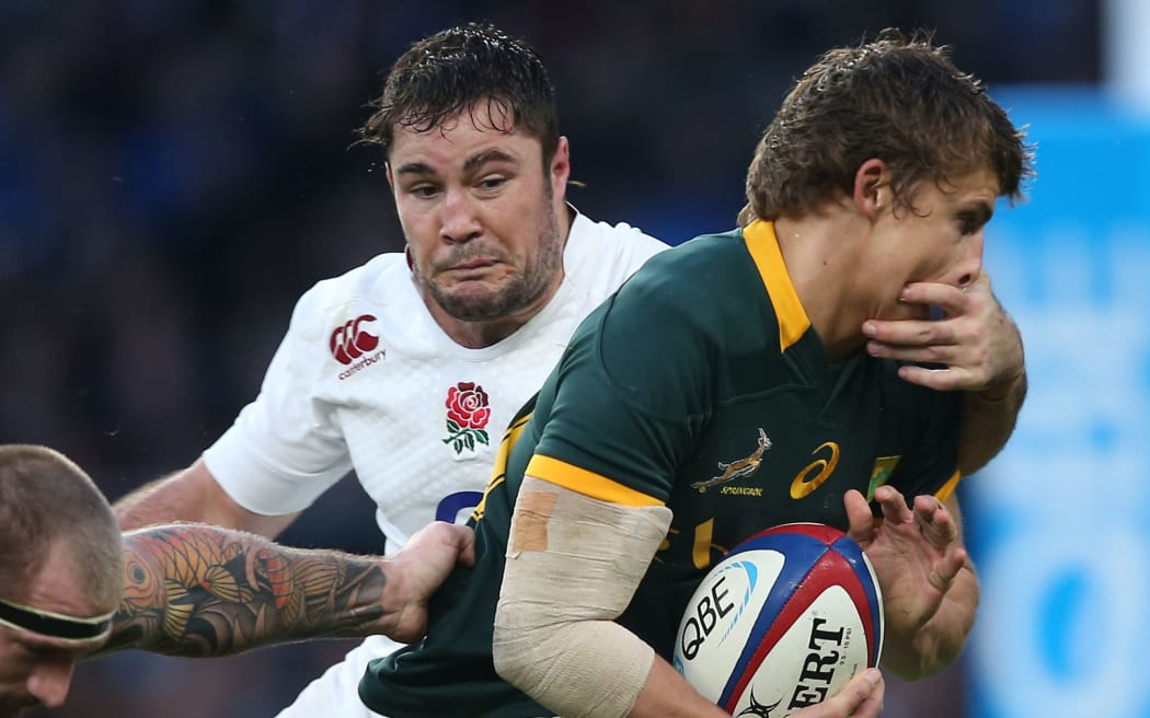 Englishman Brad Barritt tackles South Africa's Pat Lambie