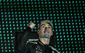 Mercedes' George Russell celebrates victory in the Formula One Singapore Grand Prix night race at the Marina Bay Street Circuit, 6 October 2025. (Photo by Lillian SUWANRUMPHA / AFP)