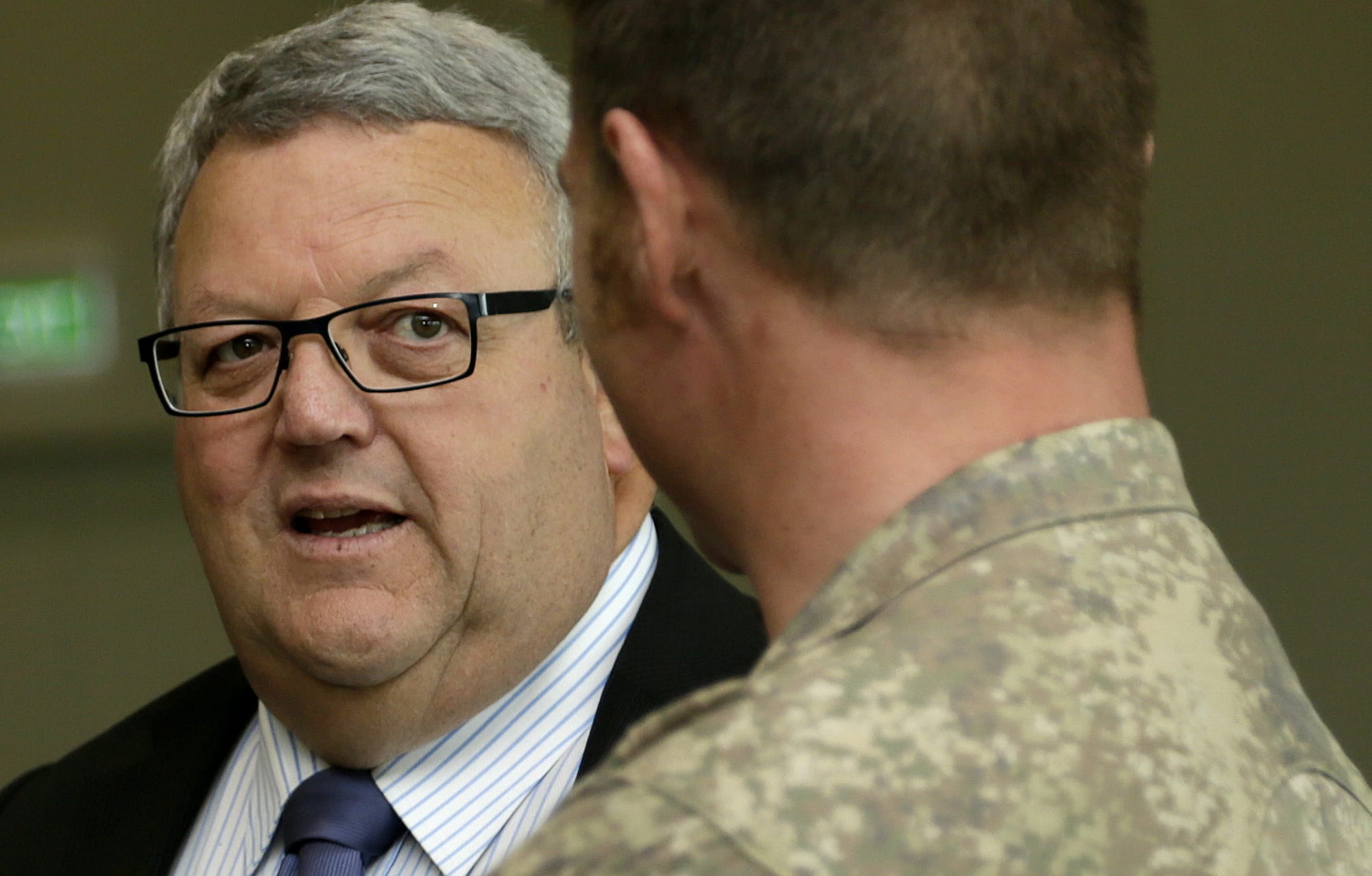Troops returning from Iraq are welcomed by Defence Minister Gerry Brownlee at Ohakea Air Base on 16 November 2015.