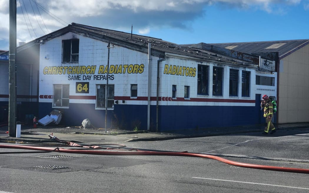 Firefighters are at the scene of a commercial fire on Buchan Street in Sydenham on 17 August, 2023. The fire appears to be at Christchurch Radiators and firefighters could be seen dampening down hotspots.