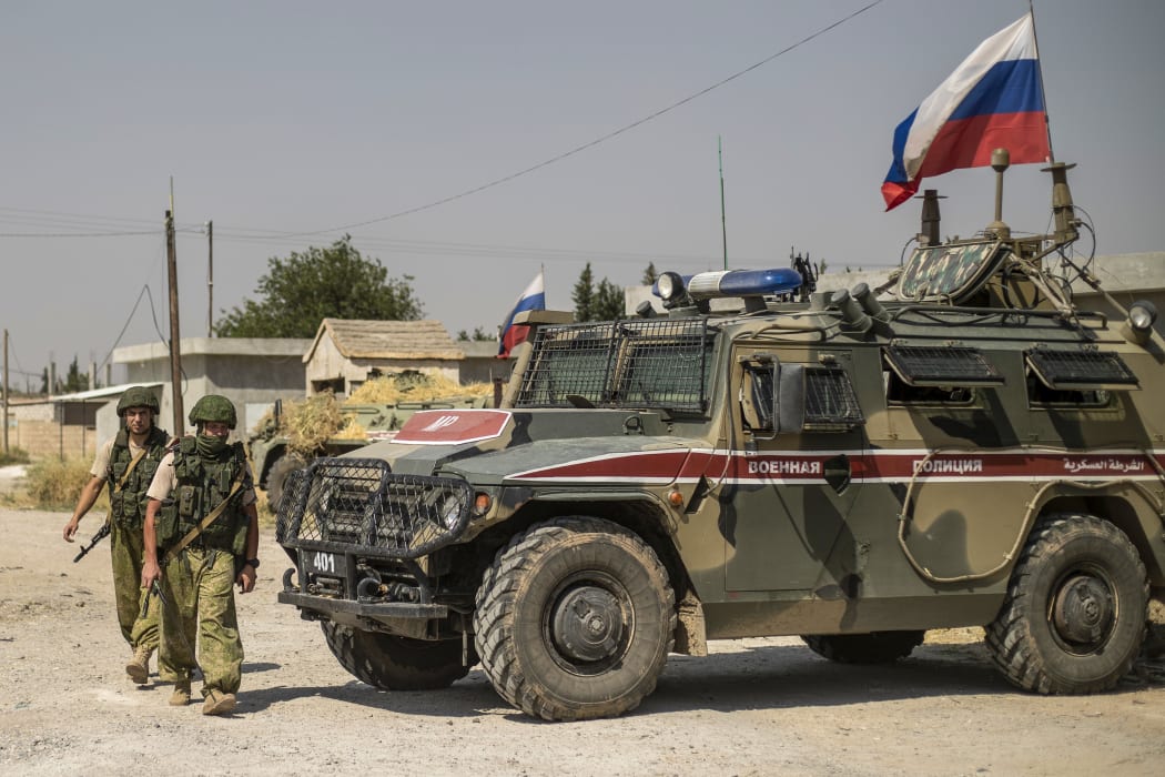 Russian soldiers reposition in the town of Derouna Arha near the Syrian border with Turkey on June 16, 2020.
