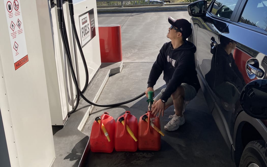 Jake fills fuel containers at Costco in  West Auckland.