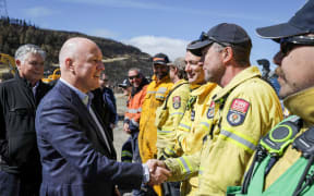 Prime Minister Christopher Luxon speaking with firefighting crews at Port Hills, Canterbury, on 22 February, 2024.