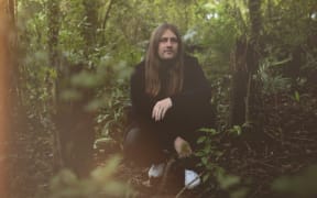 Tom Lark, crouching in the bush.