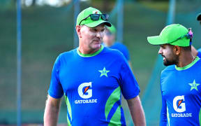 Pakistan's captain Babar Azam (R) talks with his team coach Grant Bradburn, 2023.