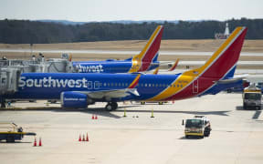 (FILES) In this file photo taken on March 13, 2019 a Boeing 737 Max 8 flown by Southwest Airlines sits at the gate at Baltimore Washington International Airport  near Baltimore, Maryland.