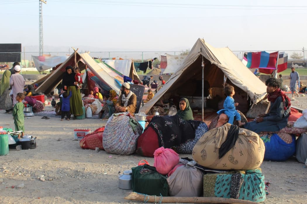 Afghan refugees rest in tents at a makeshift shelter camp in Chaman, a Pakistani town at the border with Afghanistan, after the US pulled all its troops out of Afghanistan to end a brutal 20-year war.