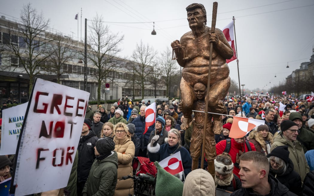 COPENHAGEN 2026-01-17
A statue of Trump, Greenlandic and Danish flags and placards as protesters gathered outside the US embassy in Copenhagen during a demonstration January 17, 2025 under the slogans "Hands off Greenland" and "Grønland for Grønlændere". 
Photo: Johan Nilsson / TT / Code 50090 (Photo by JOHAN NILSSON / TT News Agency via AFP)