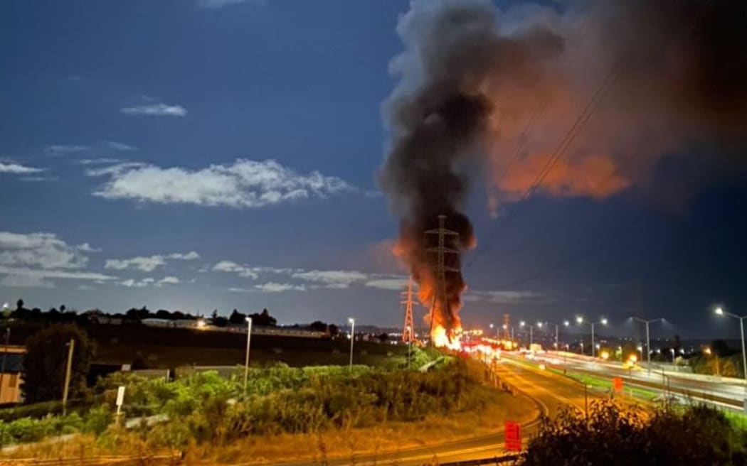 A truck carrying canisters containing highly flammable gas in flames on Auckland's southern motorway on 8 March 2023.