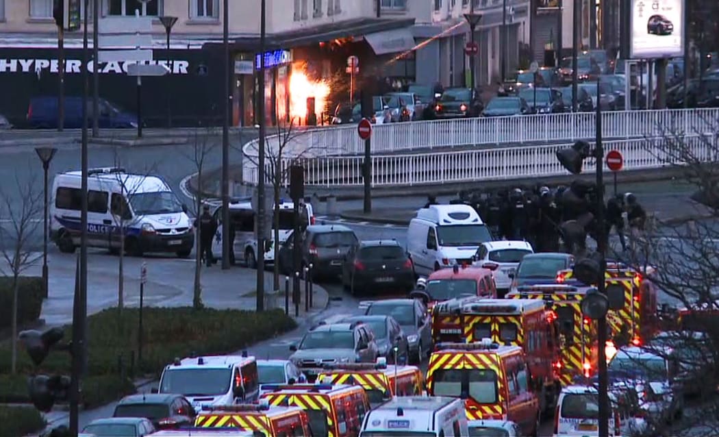 A screengrab taken from an AFP TV video shows French police special forces launching the assault at the kosher grocery store in Porte de Vincennes, eastern Paris.
