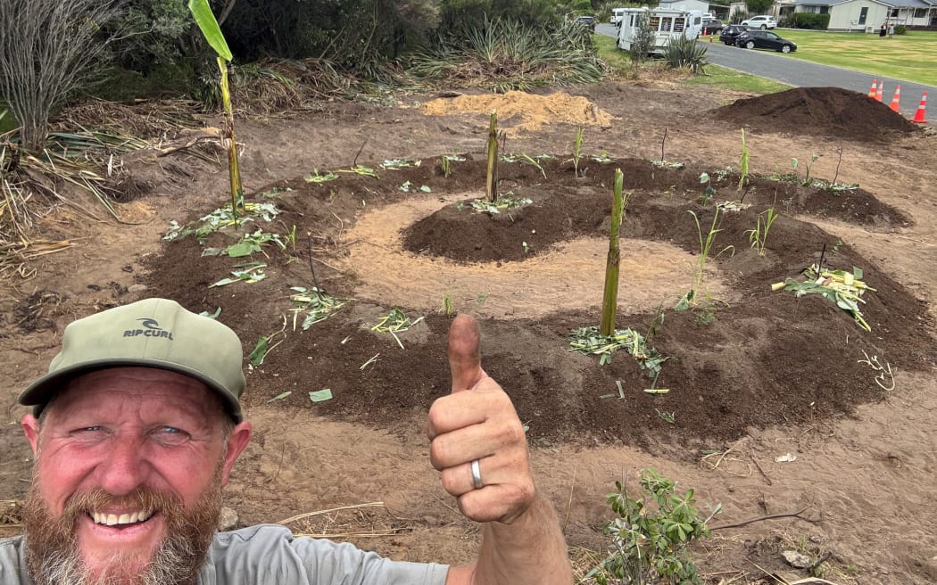 Food forest enthusiast Kris Edgington in front of a garden he's just started establishing.
