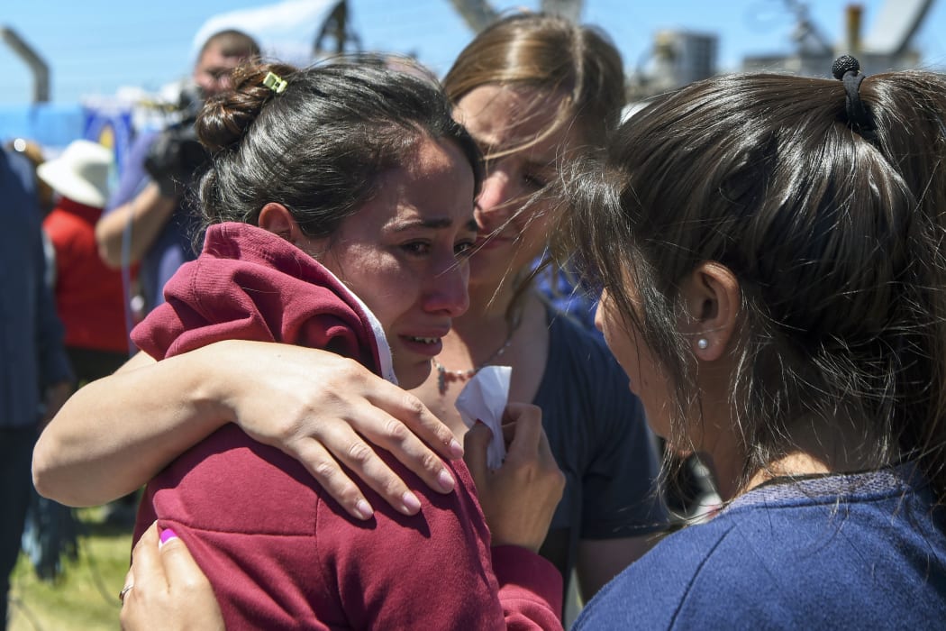 A relative of one of the 44 crew members of Argentine missing submarine, is comforted outside Argentina's Navy base in Mar del Plata.