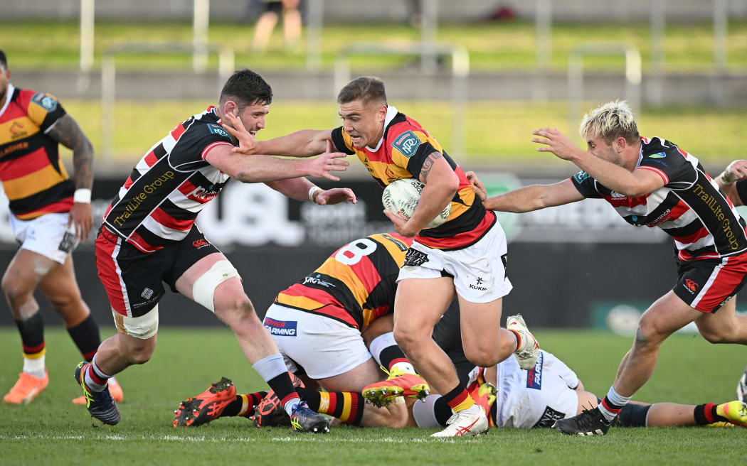 Cortez Ratima of Waikato puts in a fend.