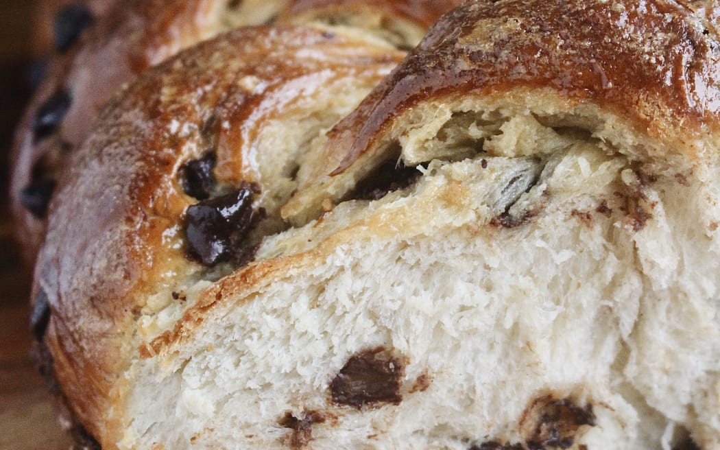 Image of a sliced open loaf of chocolate-studded bread.