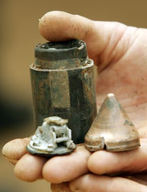 A French UN peacekeeper in Lebanon holds an inert Israeli cluster bomblet. 14 May 2007. At least 28 people have been killed and 177 injured by the weapons since the conflict ended in 2006, according to the UN.