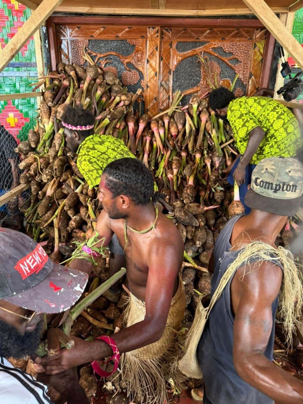 Head of State Nikenike Vurobaravu (left) and the President of the Malvatumauri Council of Chief, Ravun Merhimba DangDang, open the doors to the Nakamal. Pictured on Mar. 5, 2025.