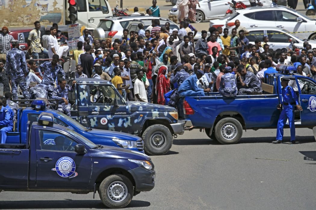 Sudanese rescue teams and security forces gather next to damaged vehicles at the site of an assassination attempt against Sudan's Prime Minister Abdalla Hamdok, who survived the attack with explosives unharmed, in the capital Khartoum on March 9, 2020.
