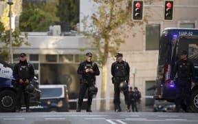 Spanish police stand guard near the US embassy in Madrid, on 1 December, 2022, after it received a letter bomb similar to one which went off at the Ukrainian embassy,