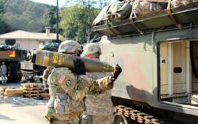This handout picture dated September 20, 2016 courtesy DVIDS obtained on July 7, 2023 shows Soldiers from Alpha Battery, 1st Battalion, 82nd Field Artillery Regiment, 1st Armored Brigade Combat Team, 1st Cavalry Division, participate in a load exercise directed by the 210th Field Artillery Brigade, 2nd Infantry Division. The United States announced July 7, 2023 that it will provide cluster munitions to Ukraine for the first time as Kyiv's forces push ahead with a counteroffensive against Russian forces. (Photo by Handout / DVIDS / AFP) / RESTRICTED TO EDITORIAL USE - MANDATORY CREDIT "AFP PHOTO / DVIDS " - NO MARKETING - NO ADVERTISING CAMPAIGNS - DISTRIBUTED AS A SERVICE TO CLIENTS