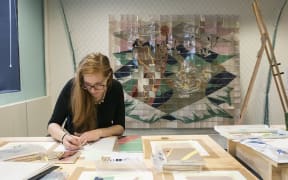 Bronwyn Holloway-Smith creating designs for 16 missing tiles in the mural Te Ika-a-Māui by E. Mervyn Taylor.