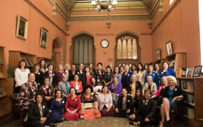 Women MPs recreate a photo of all male MPs taken in 1905 in the Reading Room of the Parliamentary Library.