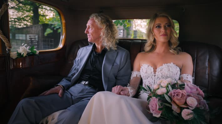 A still from Love Is Blind UK season 2, showing participant Ashleigh Berry and her father.