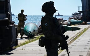 Russian soldiers patrol the sea port in the city of Mariupol on 12 June, 2022.