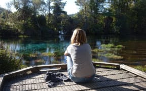 A tourist at Golden Bay's Te Waikoropupu Springs