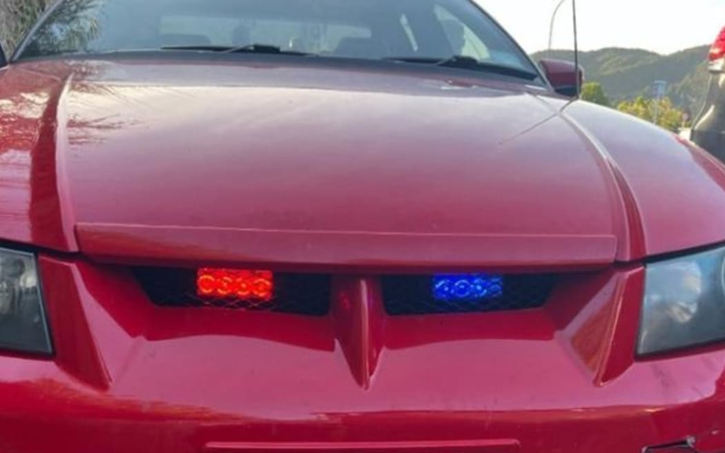 The Commodore had been fitted with red and blue lights in the front grille, like an undercover police car.