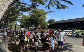 Concertgoers wait in a queue at today's Laneway Festival in Auckland.