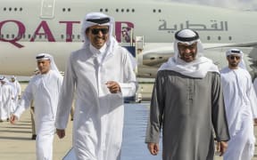 Emirati President Sheikh Mohamed bin Zayed Al-Nahyan (right) welcoming Qatar's Emir, Sheikh Tamim bin Hamad al-Thani, at the presidential airport in the capital Abu Dhabi on 18 January, 2023.