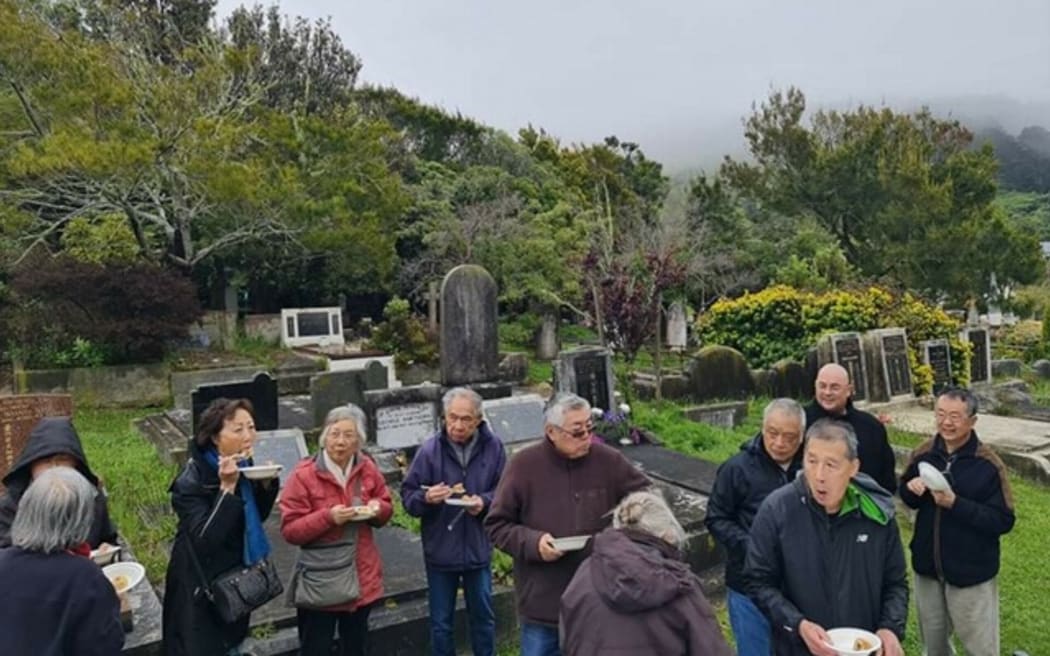 Eating with the ancestors at the Tung Jung Association of New Zealand section of the Karori Cemetery, Wellington, on Lunar New Year.