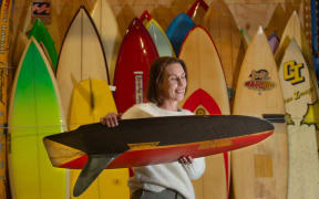 Tauranga museum curator Fiona Kean with Dusty Waddell’s collection of 130 Kiwi surfboards.