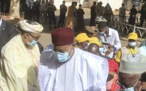 Nigerian presidential candidate Mohamed Bazoum arrives at a polling station in Niamey to cast his vote in the second round of Niger's presidential election, 21 February 2021.