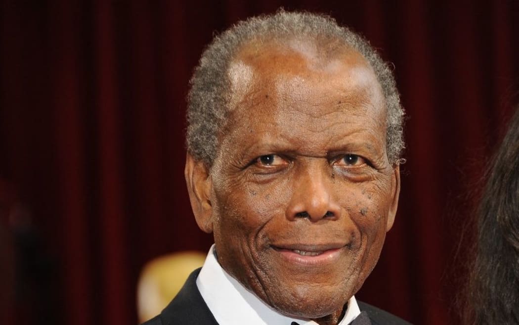 (FILES) In this file photo taken on March 02, 2014, Actor Sidney Poitier arrives on the red carpet for the 86th Academy Awards 2014 in Hollywood, California. -