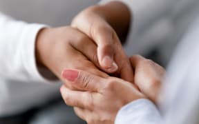 Close up caring African American mother holding child hands, showing love and support, black mum comforting, caressing kid, children protection concept, family enjoying moment together