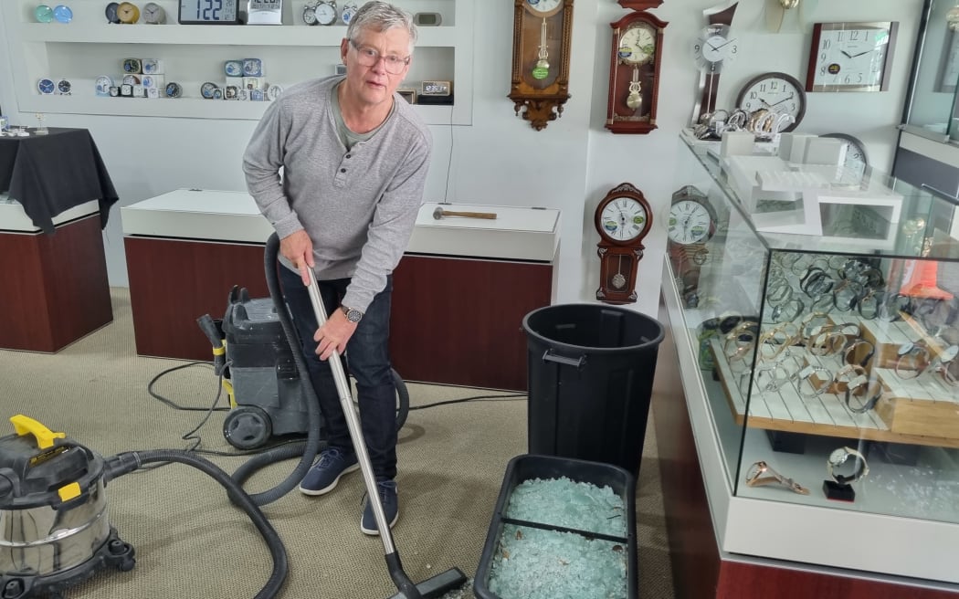 Jeweller Ross Byers cleaning up after his Devon Street store was broken into in the early hours of the morning.
