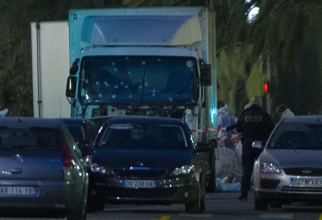 A truck with its windscreen riddled with bullets is seen on a street on July 15, 2016, after it ploughed into a crowd leaving a fireworks display in the French Riviera town of Nice.