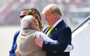 India's Prime Minister Narendra Modi (left) embraces US President Donald Trump upon his arrival at Sardar Vallabhbhai Patel International Airport on 24 February, 2020.