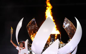 Naomi Osaka, Japanese tennis player, ignites the torch during the Opening Ceremony of the Tokyo 2020 Olympic Games at National Stadium in Tokyo on July 23rd, 2021.