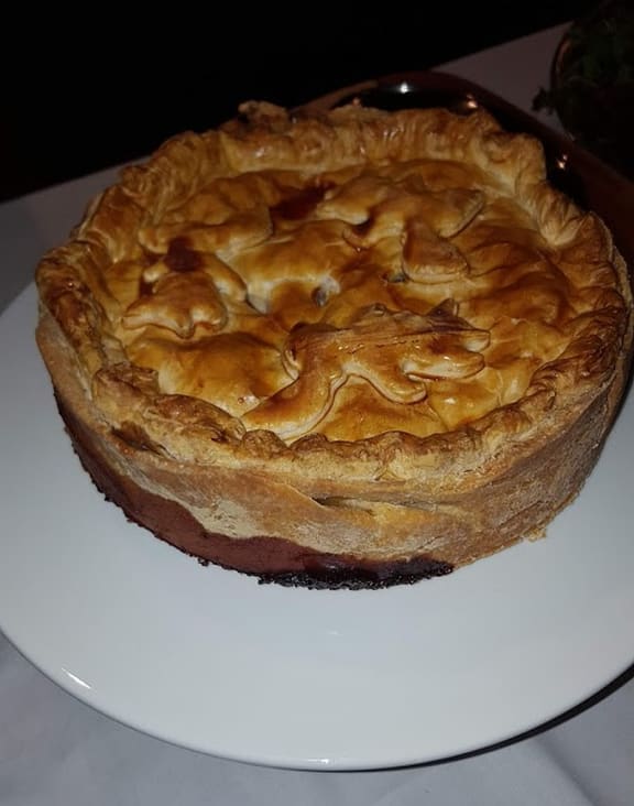 An image of a Game Pie on display at the Symposium of Gastronomy.