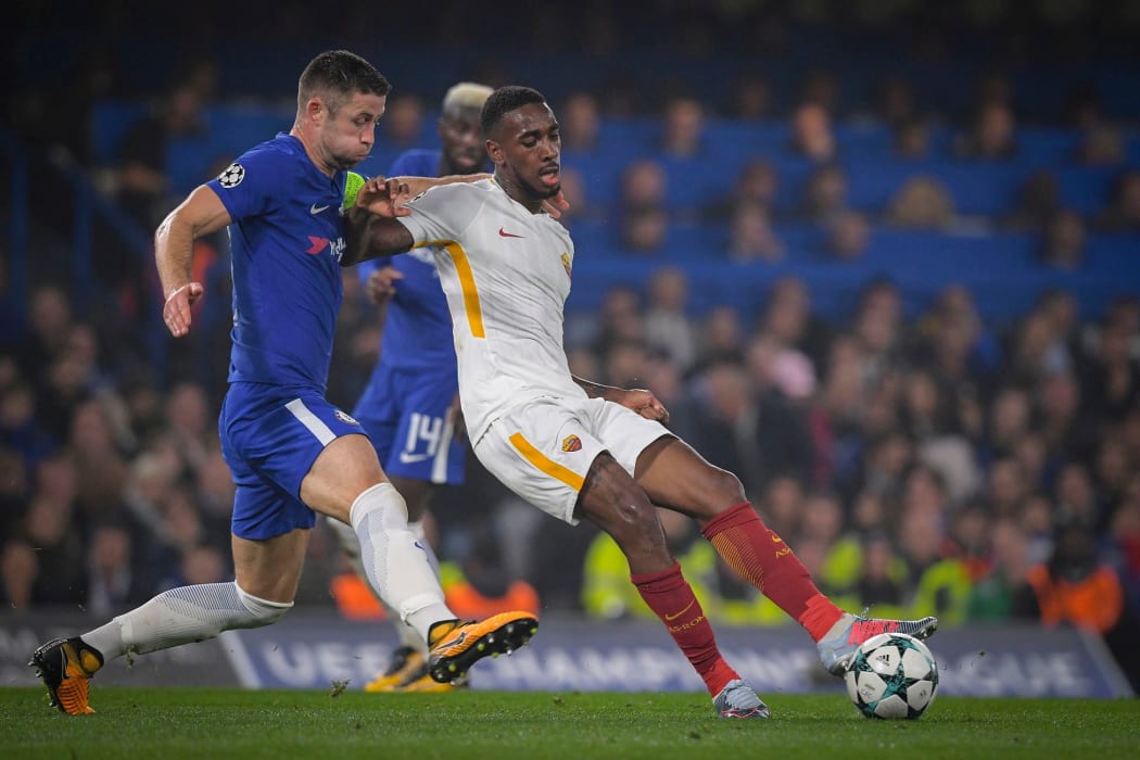 Chelsea defender Gary Cahill and AS Roma's Gerson battle for possession.