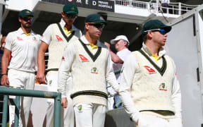 Steve Smith (right) and David Warner (centre) take to the field during Day 4 of the controversial test against South Africa in Capetown.