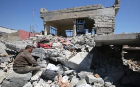 This file photo taken on March 26, 2017 shows an Iraqi man amid the rubble of destroyed houses in the Mosul al-Jadida area, following air strikes in which civilians have been reportedly killed during an ongoing offensive against the Islamic State (IS) group.
