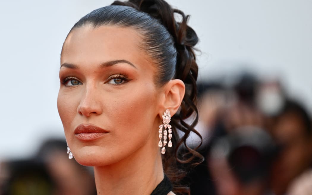 US model Bella Hadid arrives for the screening of the film "L'Amour Ouf" (Beating Hearts) at the 77th edition of the Cannes Film Festival in Cannes, southern France, on May 23, 2024. (Photo by Christophe SIMON / AFP)