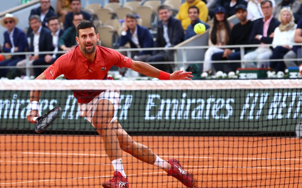Serbia's Novak Djokovic eyes the ball during his men's singles round of sixteen match against Argentina's Francisco Cerundolo on Court Philippe-Chatrier on day nine of the French Open tennis tournament at the Roland Garros Complex in Paris on June 3, 2024.