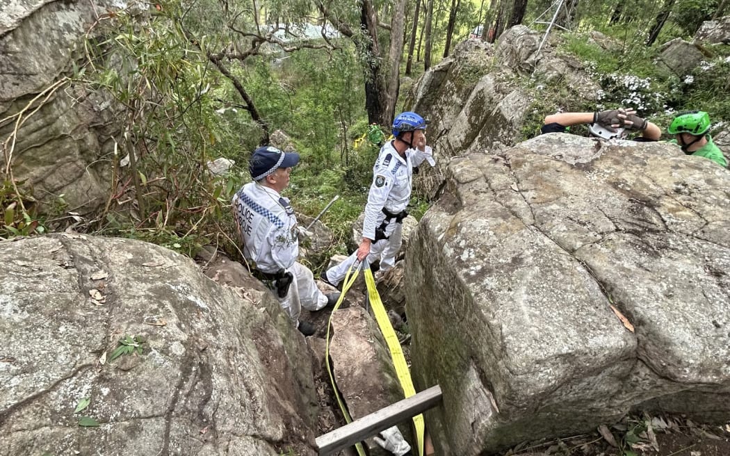 The woman was wedged between rocks near an overgrown bush track.