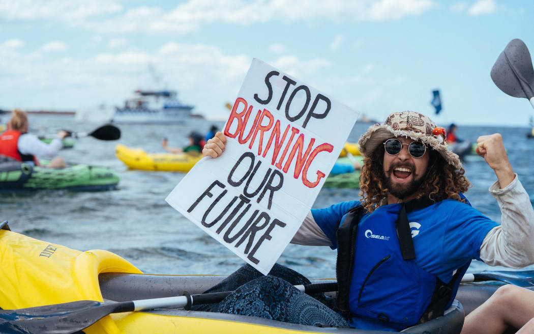 Protestors calling on the government to stop approving new fossil fuel projects.