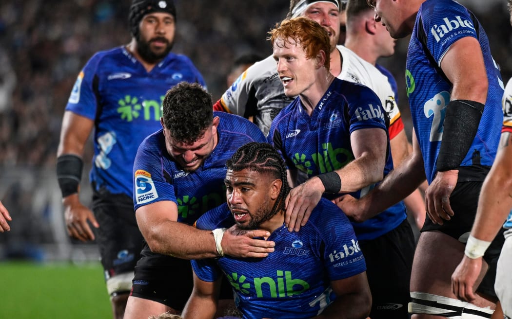 Finlay Christie and Blues team celebrate a try by Hoskins Sotutu of the Blues.